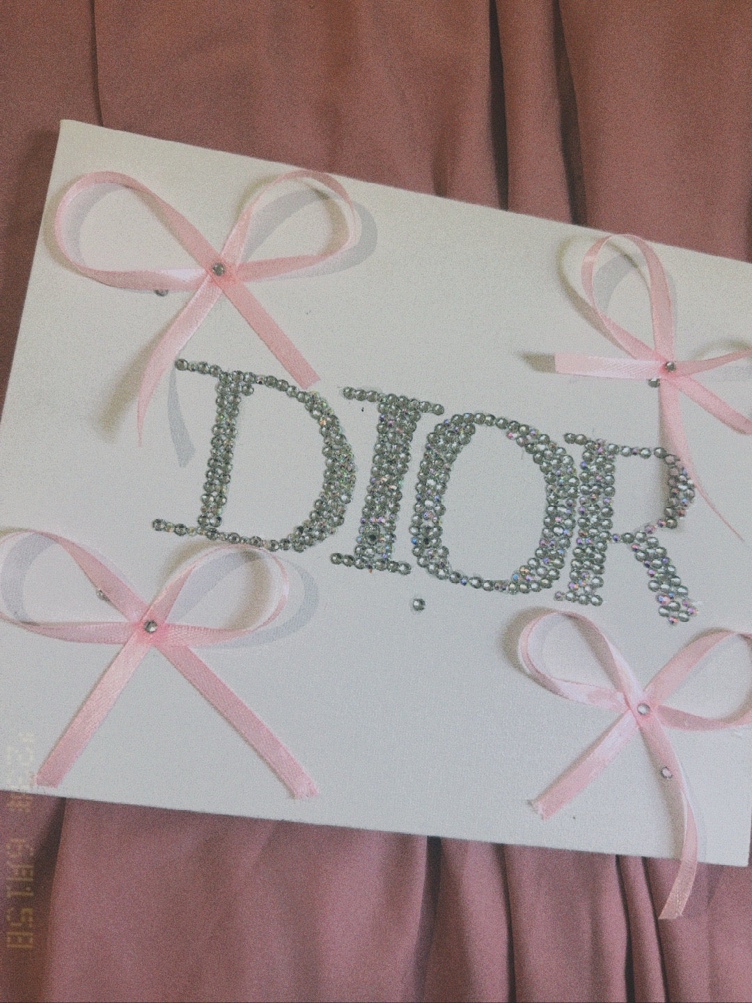 “DIOR” rhinestone canvas art with ribbons