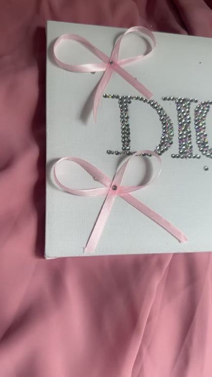 “DIOR” rhinestone canvas art with ribbons